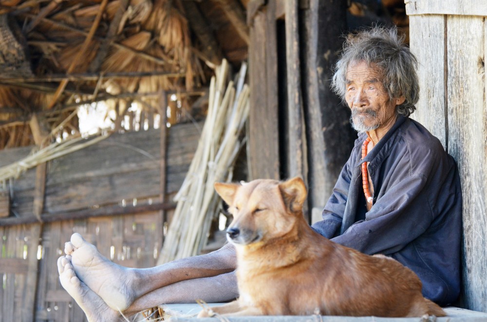 An old man sunbaths outside the morung with his pet dog on a lazy Sunday morning at Monyakshu village, Mon District. (Photo Courtesy/Meren Pongen)